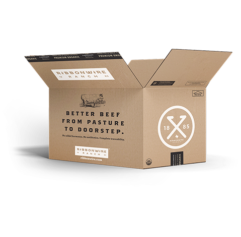 An open brown cardboard shipping box branded Ribbonwire Beef, with printed text and logos on the front and inside flaps, photographed on a clean white background.