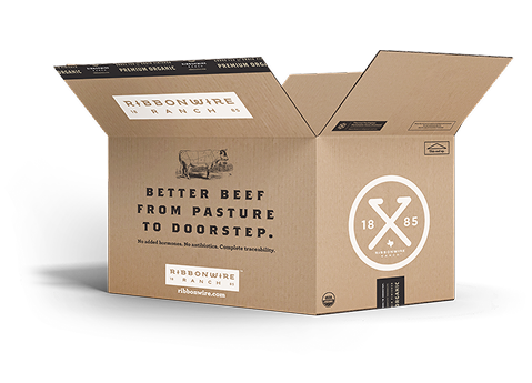 An open brown cardboard shipping box branded Ribbonwire Beef, with printed text and logos on the front and inside flaps, photographed on a clean white background.