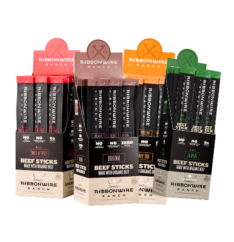 Three display cartons of Ribbonwire Ranch beef sticks on a white background, showing beef sticks in red, brown, and green flavors.
